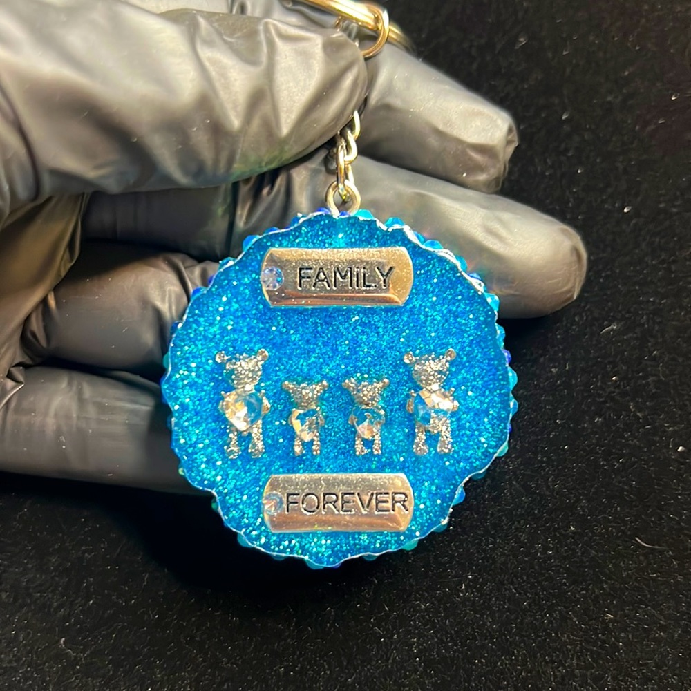 Resin keychain. Clear blue glitter, rhinestones, silver chrome trim and charms🩵